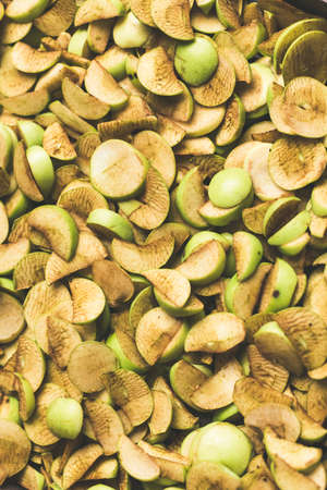 The process of home cooking dried fruits in an electric dryer. The stage of dehydration of fruits for storage and consumption in the winter. Lots of dehydrated apples.の写真素材