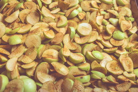 The process of home cooking dried fruits in an electric dryer. The stage of dehydration of fruits for storage and consumption in the winter. Lots of dehydrated apples.の写真素材