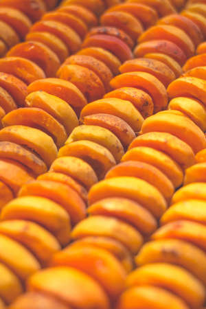 The process of home cooking dried fruits in an electric dryer. The stage of dehydration of fruits for storage and consumption in the winter. Lots of dehydrated apricots.の写真素材