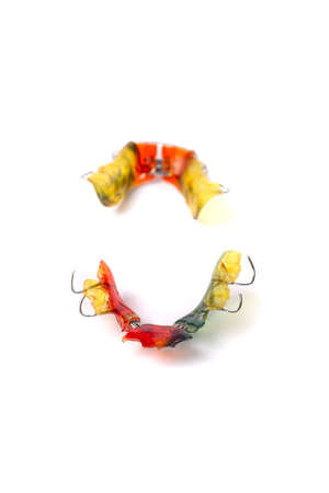 Colorful children's orthodontic appliances isolated on white background. Concept of oral health in childhood. studio photo.の写真素材