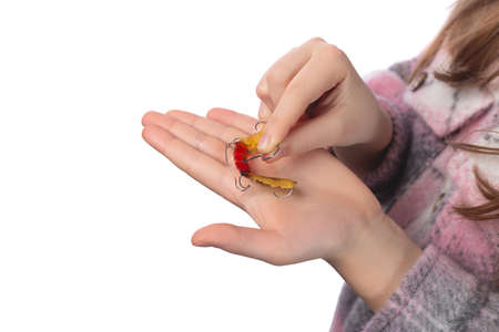 The child holds in his hands an orthodontic appliance and a key to adjust it. The concept of teeth alignment in childhood. Studio photo on a white background.の写真素材