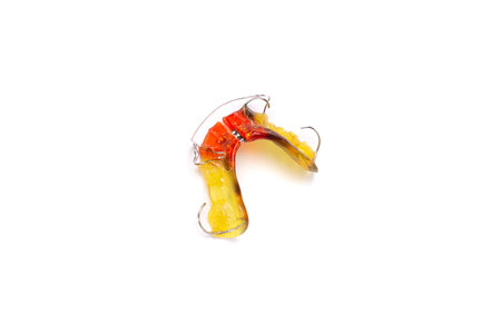 Colorful children's orthodontic appliance isolated on white background. Concept of oral health in...