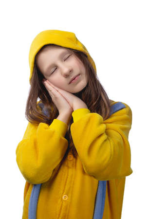 Little cute cheerful girl 10 years old posing in yellow pajamas. Studio photo on a white background.の写真素材