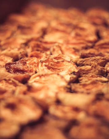 The process of home cooking dried fruits in an electric dryer. The stage of dehydration of fruits for storage and consumption in the winter. Lots of dehydrated apricots.の写真素材