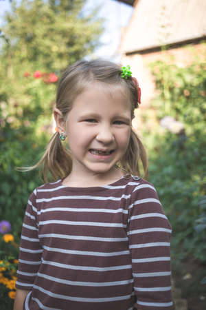 Child with a dental orthodontic device and without one tooth.の写真素材