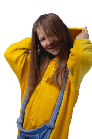 Little cute cheerful girl 10 years old posing in yellow pajamas. Studio photo on a white background.の写真素材