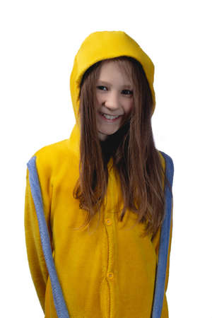 Little cute cheerful girl 10 years old posing in yellow pajamas. Studio photo on a white background.の写真素材