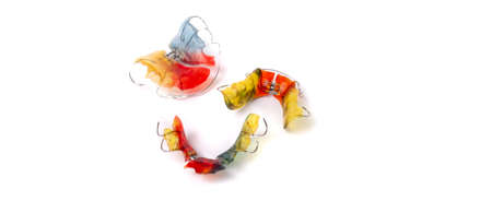 Colorful children's orthodontic appliances isolated on white background. Concept of oral health in childhood. studio photo.の写真素材