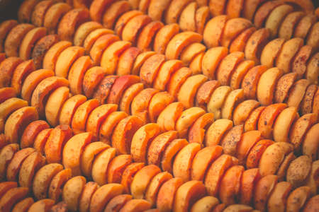 The process of home cooking dried fruits in an electric dryer. The stage of dehydration of fruits for storage and consumption in the winter. Lots of dehydrated apricots.の写真素材