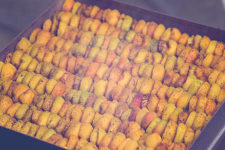 The process of home cooking dried fruits in an electric dryer. The stage of dehydration of fruits for storage and consumption in the winter. Lots of dehydrated apricots.の写真素材