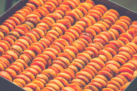The process of home cooking dried fruits in an electric dryer. The stage of dehydration of fruits for storage and consumption in the winter. Lots of dehydrated apricots.の写真素材