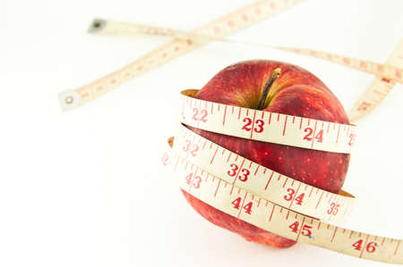 Red apple with tape isolated on white (good shape and good health concept)の写真素材