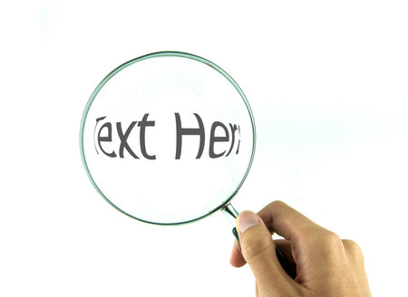 Magnifying glass in hand isolated on white backgroundの写真素材