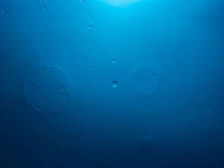 Abstract delicate bubble background in blue. Slightly blurred.