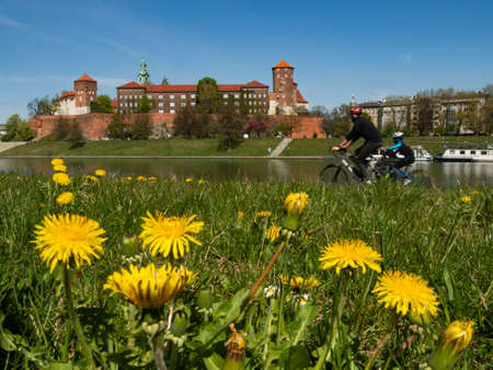 Cracow/Poland - 23/04/2020. The former Royal residence of Polish monarchy, Wawel Castle, Krakow, Poland. Spring time, view from the Vistula river boulevard. People relaxing during the covid-19 coronavirus pandemic.のeditorial素材