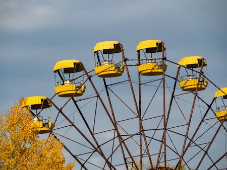 Ferris wheel in abandoned amusement park in ghost town Pripyat, post apocalyptic city, autumn season in Chernobyl exclusion zone, Ukraineの写真素材