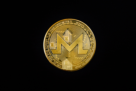 Digital currency physical metal golden monero coin. Monero closeup concept.の写真素材