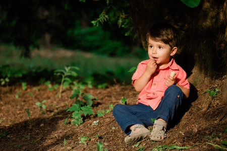 Cute little boy having fun in summer park. Happy child outdoors