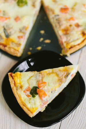 smoked salmon, Brussels sprouts and gorgonzola quiche tart, top view. Piece of homemade pieの写真素材