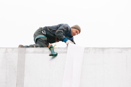Industrial climber repair billboard. Risky job. Work on height. Metal construction. Electric...