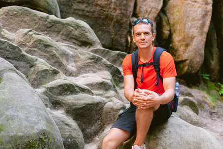 Young male hiker with backpack. Active healthy lifestyle adventure journey vacations