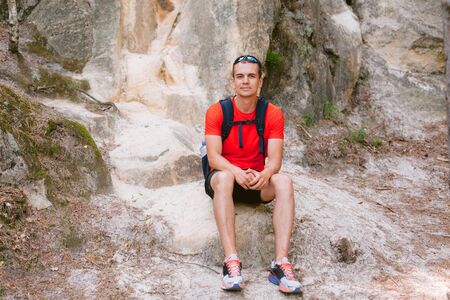 Young male hiker with backpack relaxing. Active healthy lifestyle adventure journey vacationsの写真素材
