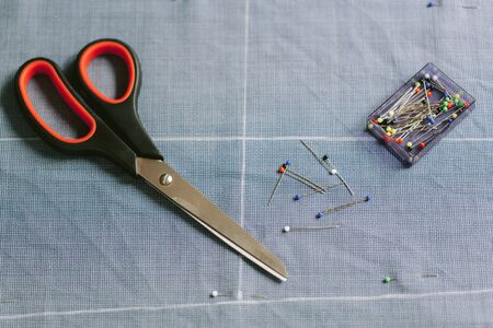 Tailor's work table. Close up. Scissors chalk needles pinsの写真素材