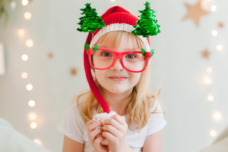 Happy cheerful Little girl in santa hat. Christmas timeの写真素材