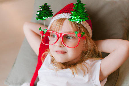 Happy cheerful Little girl in santa hat. Christmas timeの写真素材