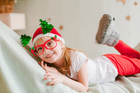 Happy cheerful Little girl in santa hat. Christmas timeの写真素材