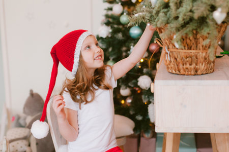 Happy cheerful Little girl in santa hat. Christmas time.の写真素材
