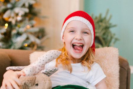 Happy cheerful Little girl in santa hat. Christmas timeの写真素材