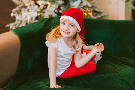 Happy cheerful Little girl in santa hat. Christmas timeの写真素材