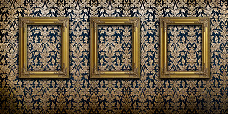 Gold picture frames on Thai traditional pattern wallの写真素材