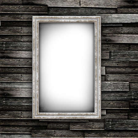 Grunge wood floor with old frames on a wall の写真素材
