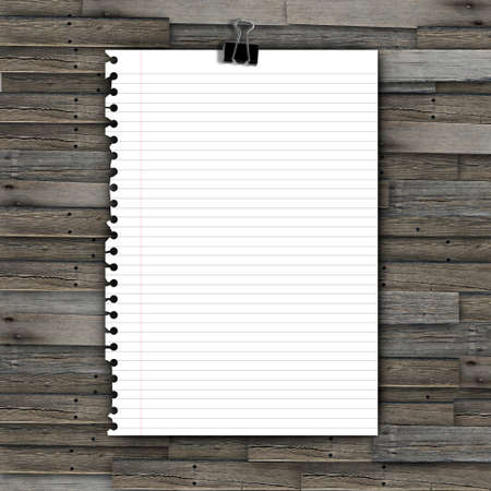 Note paper and paper clip on wooden backgroundの写真素材