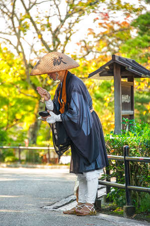 Kiyomizu Dera Temple, Kyoto, Japan - October 18, 2016: ALMS RITUAL. A Japanese Zen Buddhist chanting as part of alms ritual in front of the temple.のeditorial素材