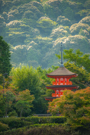 Beautiful red pagoda at Kiyomizu-dera Temple in Kyoto, Japan. A view of a three story pagoda stands in nature surrounded with sea of trees.のeditorial素材