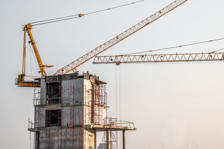 Aerial view of a building construction site in progress with tower crane