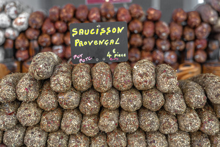 Stacks of dry-cured sausages - saucisson, typically made of pork, or a mixture of pork and other...