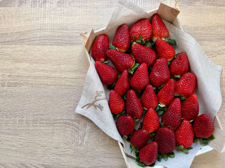 box of strawberries on wooden tableの写真素材