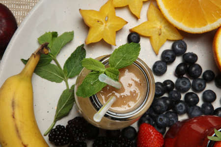 Fruit smoothies with strawberry, mint, orange and banana on white backgroundの写真素材