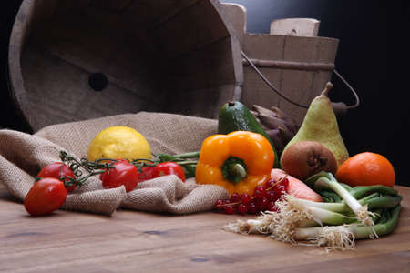 Fresh fruits and vegetables for healthy in wooden bucketの写真素材