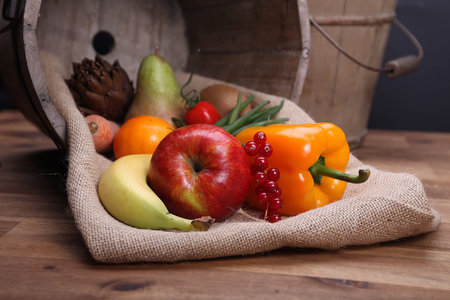 Fresh fruits and vegetables for healthy in wooden bucketの写真素材