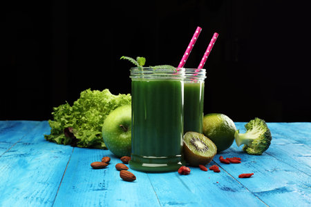 Healthy green smoothie and ingredients - superfoods, detox, diet, health, vegetarian food conceptの写真素材