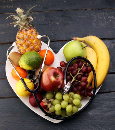 Healthy food in heart and cholesterol diet concept on vintage boardsの写真素材