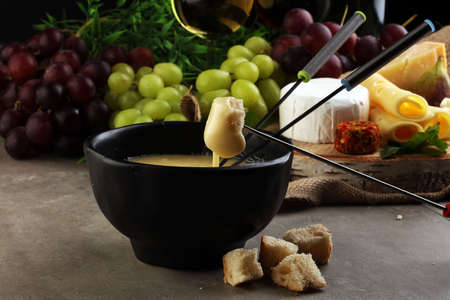 Cheese platter with different cheese and grapes and red wineの写真素材