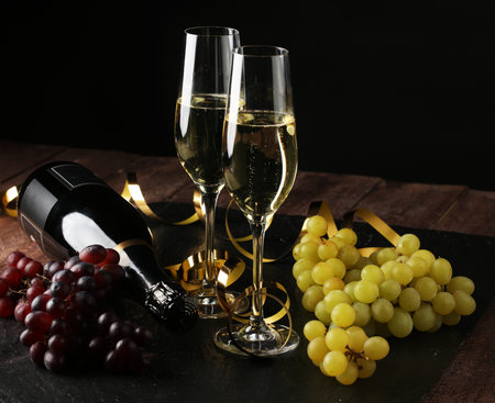 Conceptual Golden Brown Wine on Elegant Glass with Spiral Thin Wrapping Foils or Laces Decoration, on Abstract Brown Background - Champagne sylvester partyの写真素材