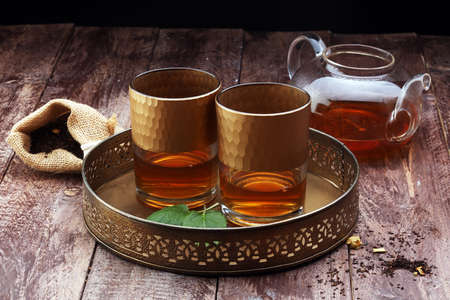 Tea. Herbal tea. Mint leaf. Tea in a glass cup, mint leaves, dried tea, sliced lime. herbs on a slate plate in a restaurant or teahouseの写真素材