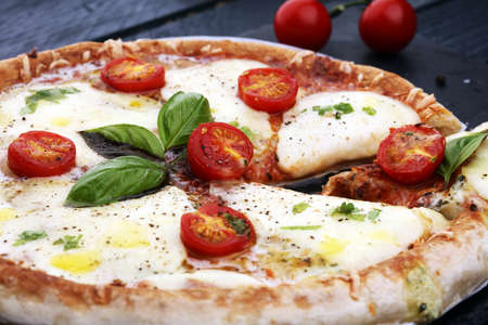 Hot true PEPPERONI ITALIAN PIZZA with salami and cheese. TOP VIEW Tasty traditional pepperoni pizza on board on wooden table with decorationの写真素材